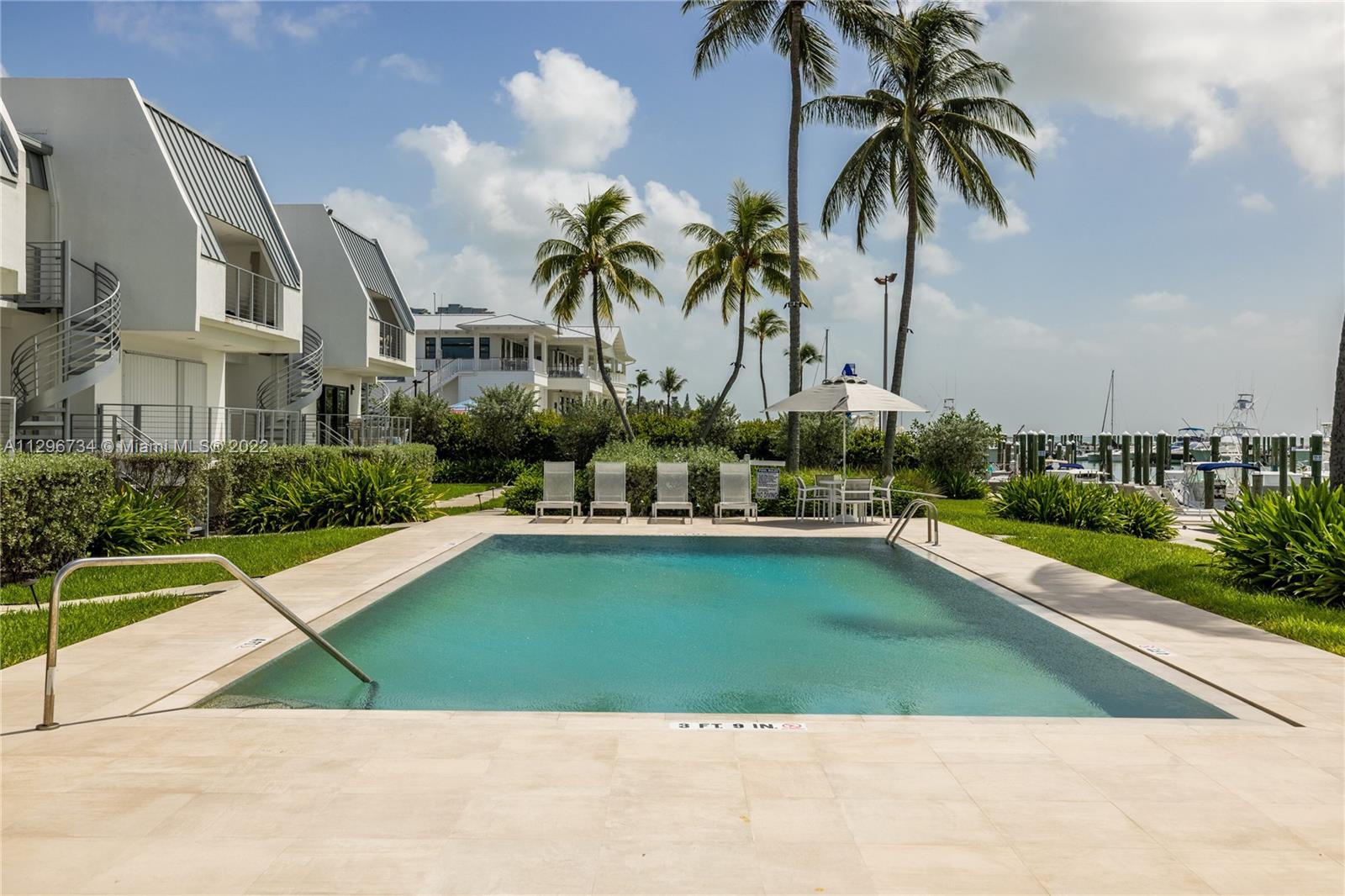 166 Harbor Drive, Unit 1A Key Biscayne, FL 33149 - Photo 73 of 86 a swimming pool with outdoor seating and yard