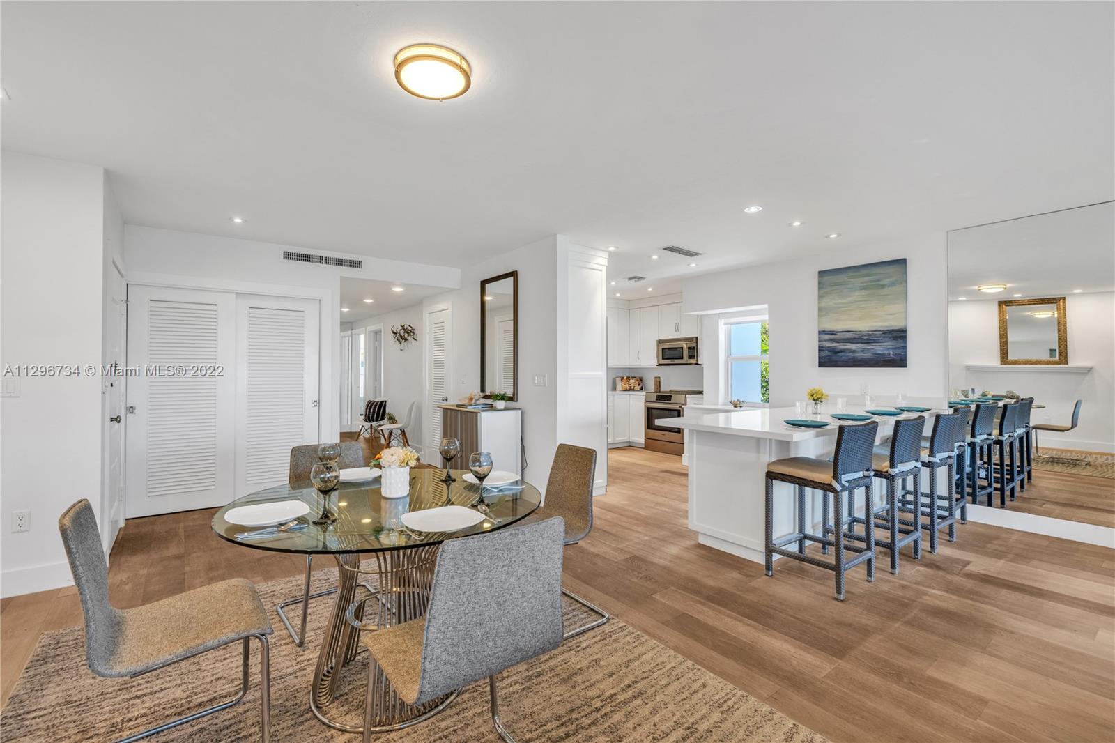 166 Harbor Drive, Unit 1A Key Biscayne, FL 33149 - Photo 8 of 86 a view of a dining room with furniture and wooden floor