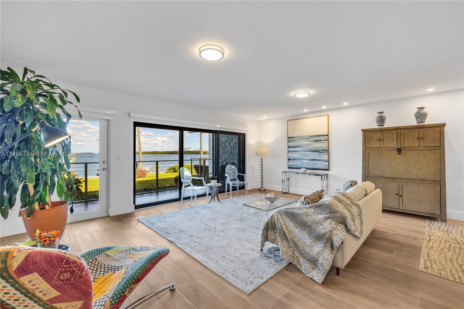 166 Harbor Drive, Unit 1A Key Biscayne, FL 33149 - Photo 10 of 86 a living room with furniture and a flat screen tv