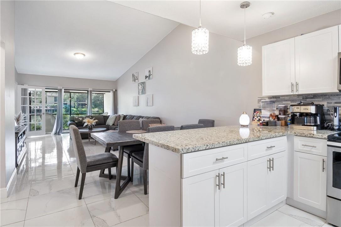 727 Banks Road, Unit 98 Margate, FL 33063 - Photo 1 of 22 a kitchen with white cabinets and sink
