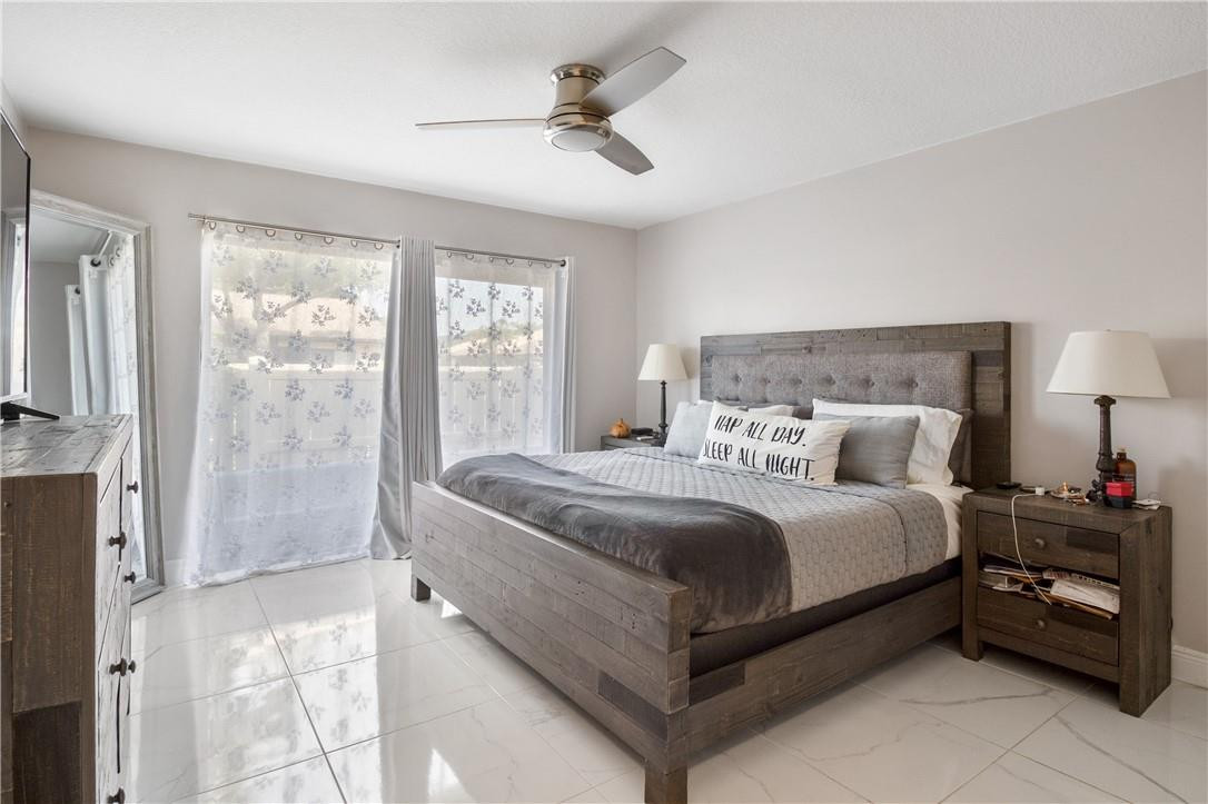727 Banks Road, Unit 98 Margate, FL 33063 - Photo 12 of 22 a bed room with a bed and a chandelier