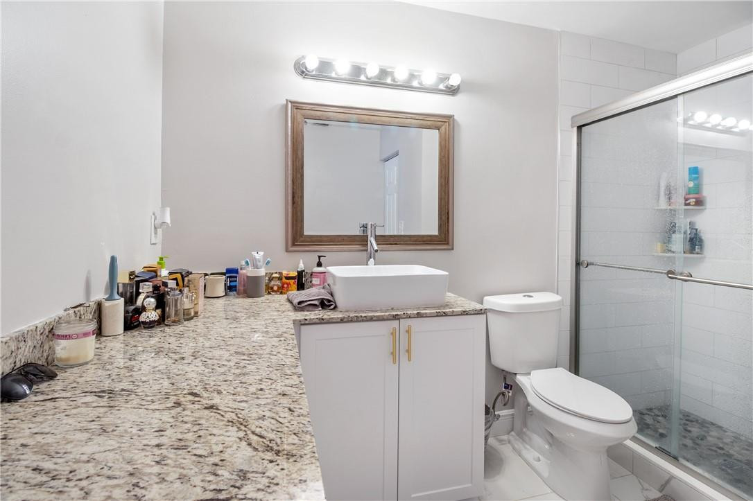 727 Banks Road, Unit 98 Margate, FL 33063 - Photo 14 of 22 a bathroom with a toilet sink and mirror