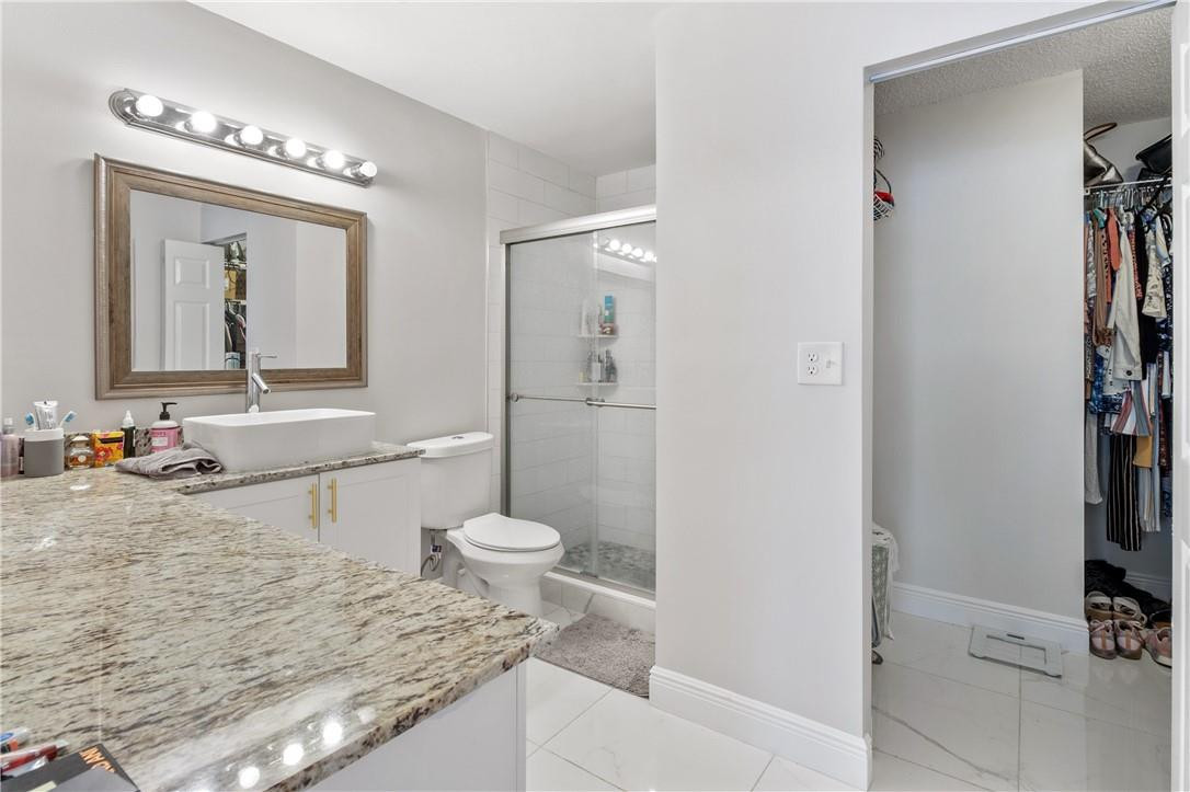 727 Banks Road, Unit 98 Margate, FL 33063 - Photo 15 of 22 a bathroom with a granite countertop sink mirror vanity and toilet
