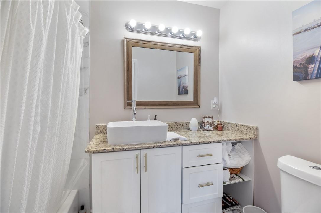 727 Banks Road, Unit 98 Margate, FL 33063 - Photo 19 of 22 a bathroom with a granite countertop sink and a mirror