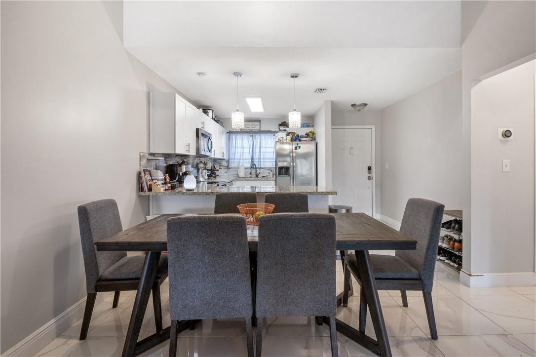 727 Banks Road, Unit 98 Margate, FL 33063 - Photo 4 of 22 a view of a dining room with furniture and a view of kitchen