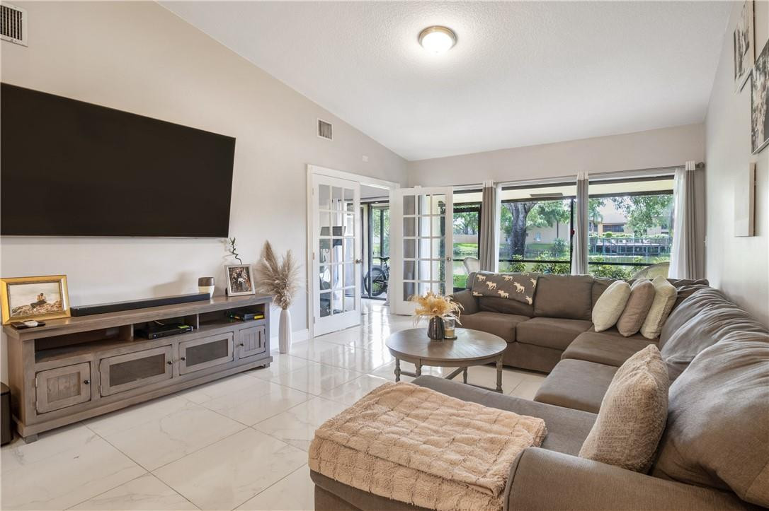 727 Banks Road, Unit 98 Margate, FL 33063 - Photo 5 of 22 a living room with furniture and a flat screen tv