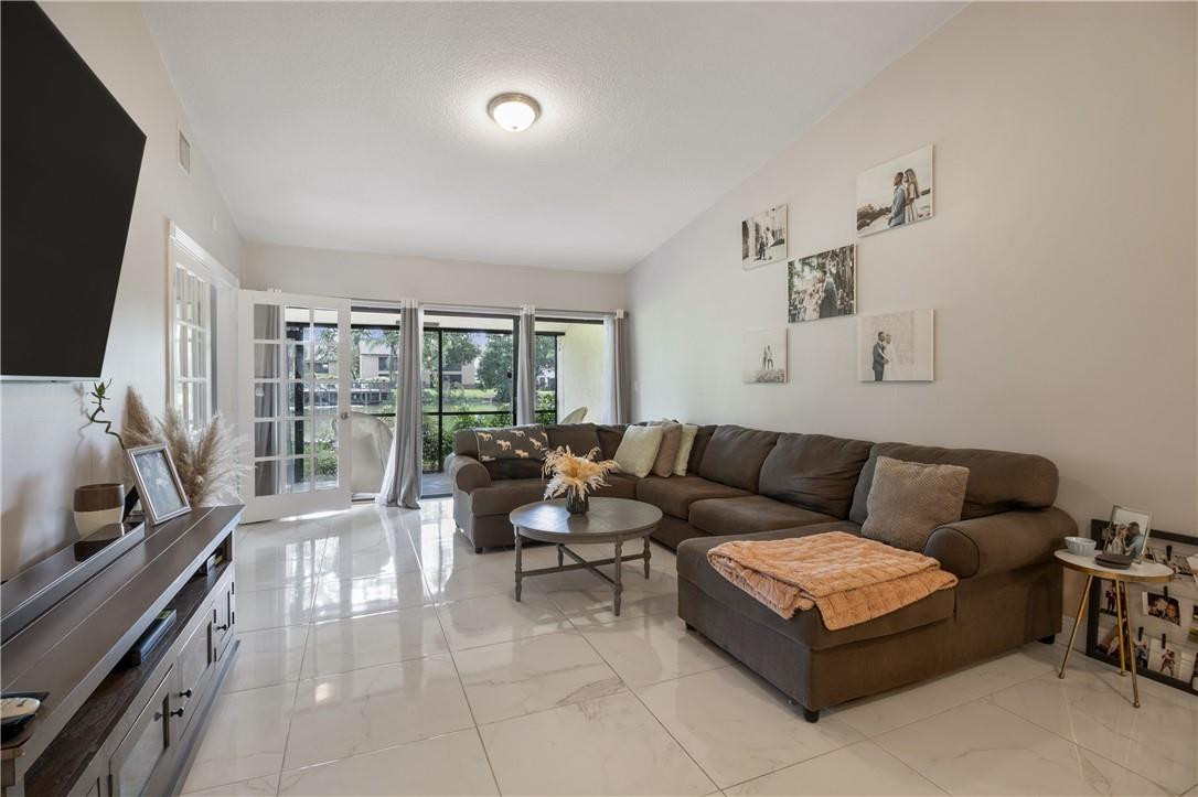 727 Banks Road, Unit 98 Margate, FL 33063 - Photo 6 of 22 a living room with furniture and a flat screen tv