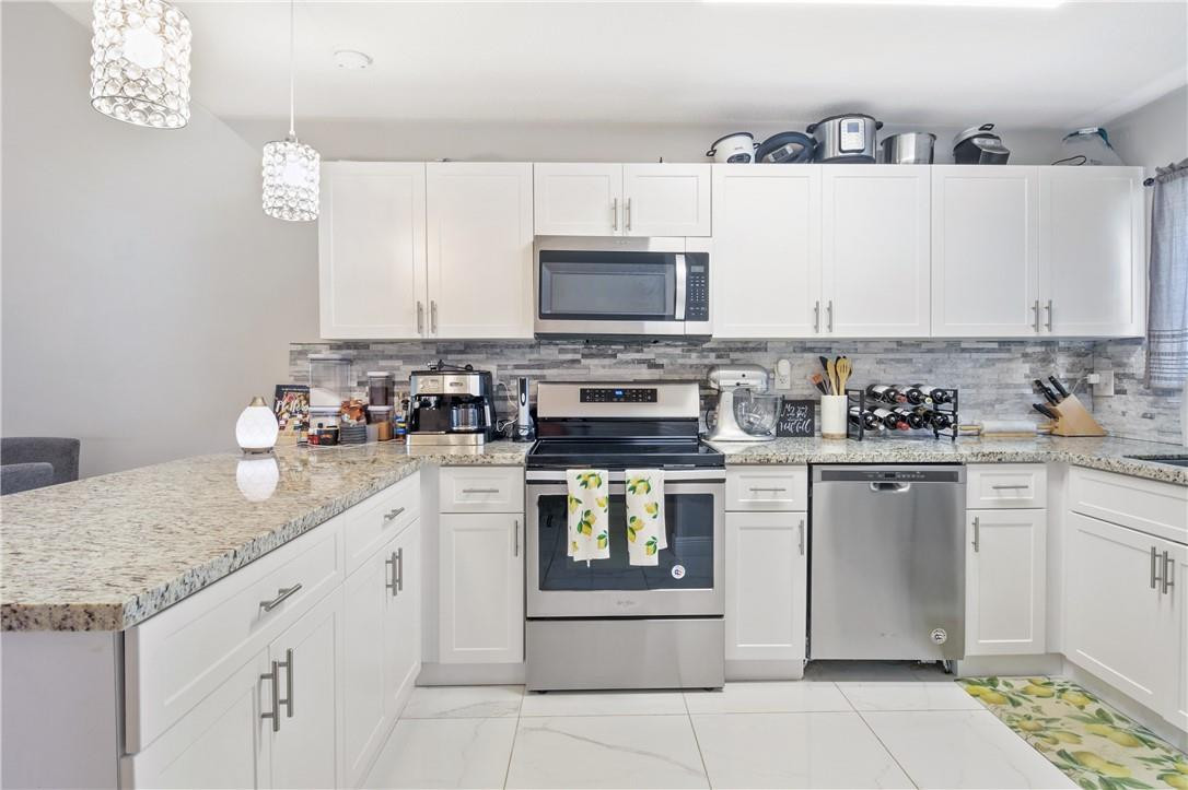 727 Banks Road, Unit 98 Margate, FL 33063 - Photo 9 of 22 a kitchen with stainless steel appliances granite countertop a sink and cabinets