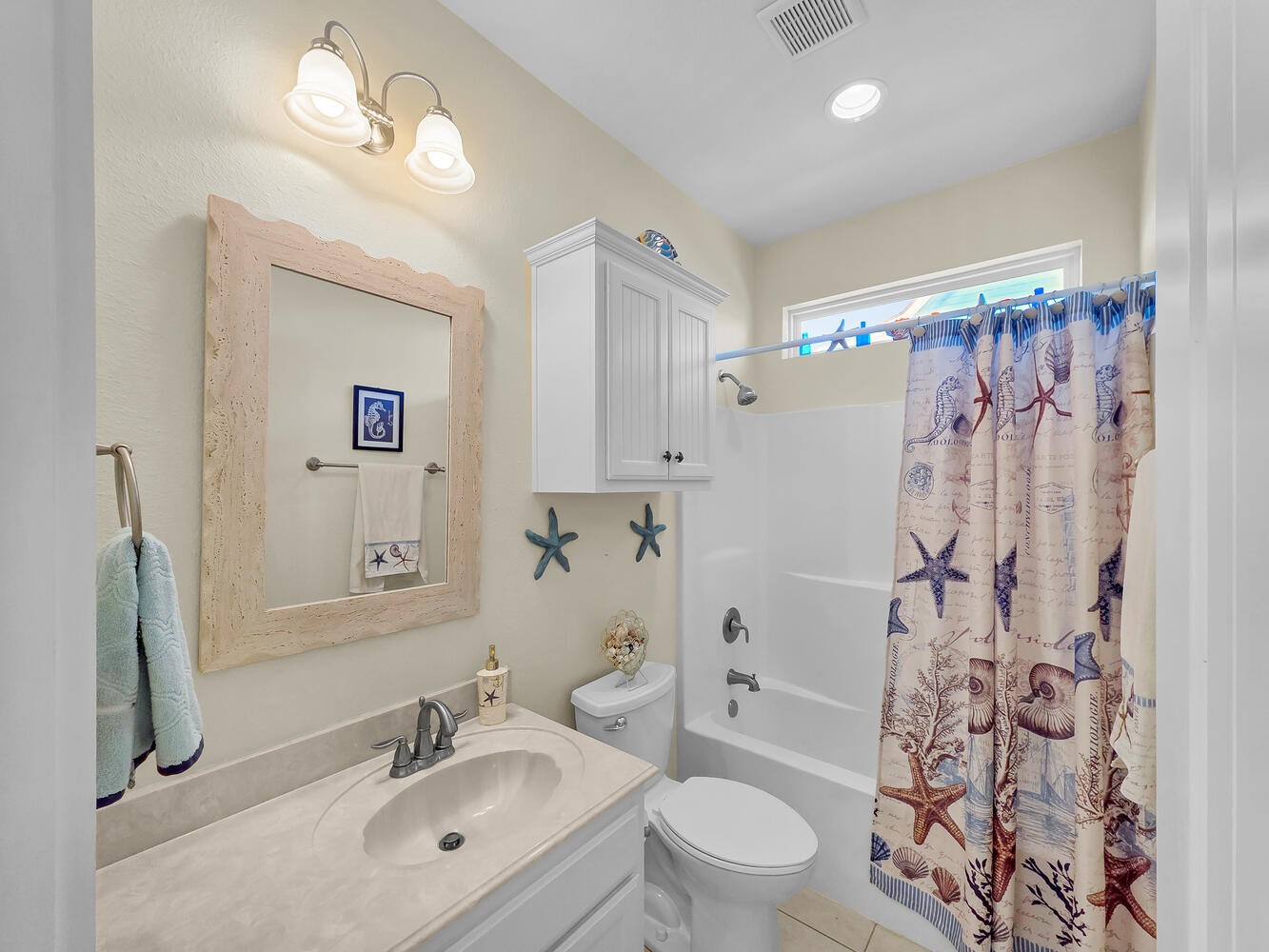 2577 Holiday Crystal Beach, TX 77650 - Photo 21 of 36 a bathroom with a sink toilet a mirror a vanity and shower
