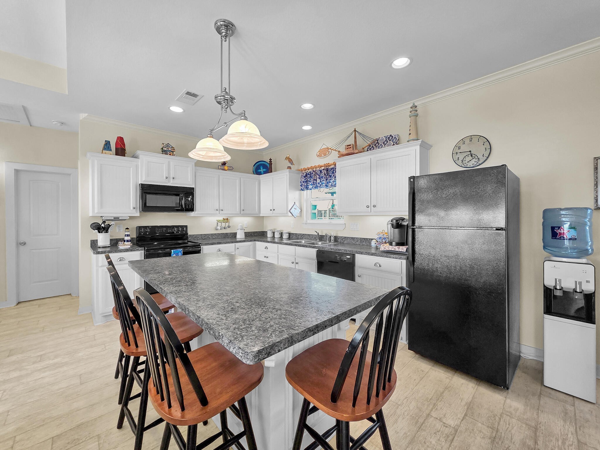 2577 Holiday Crystal Beach, TX 77650 - Photo 8 of 36 a kitchen with stainless steel appliances granite countertop a stove a refrigerator a kitchen island a sink with a stove a table and chairs