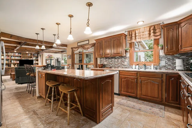 a kitchen with a sink and wooden cabinets