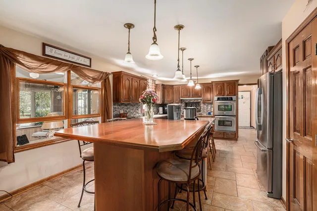 a dining table chairs and a chandelier