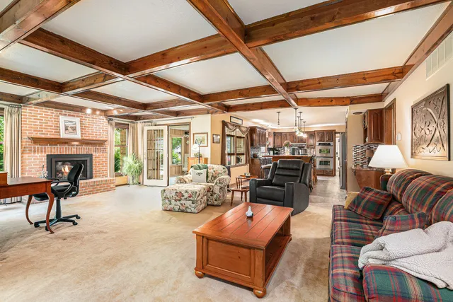 a living room with furniture a fireplace and a table