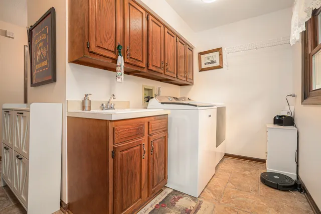a utility room with a sink a washer and dryer