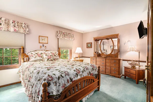 a bedroom with a bed and a large window