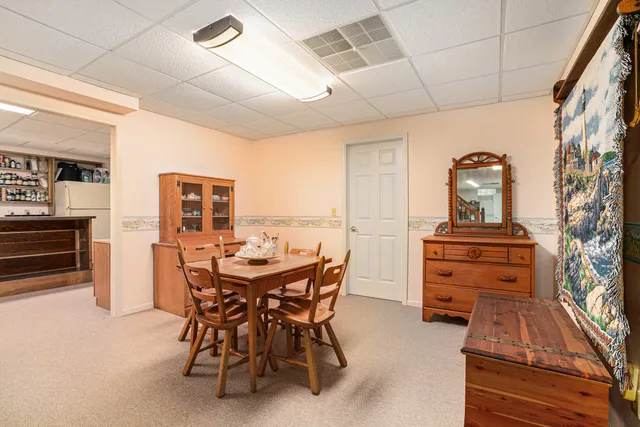 a view of a dining room with furniture and a chandelier