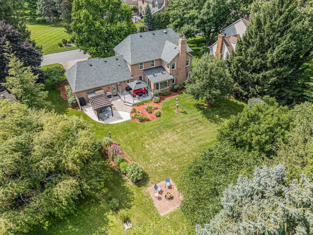an aerial view of a house with swimming pool and garden view
