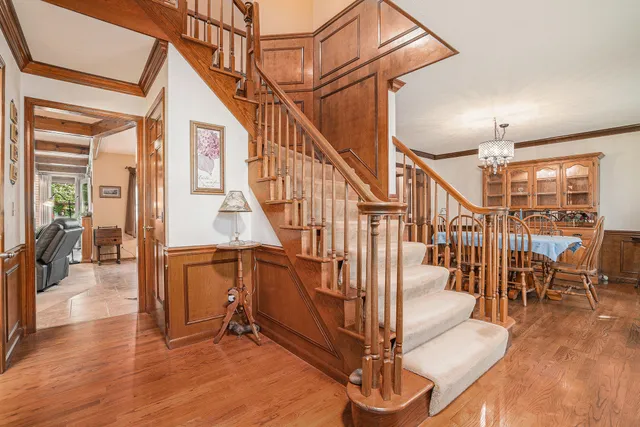 a view of entryway and hall with wooden floor