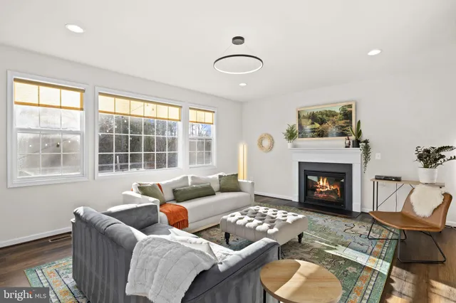 a bedroom with furniture and a large window