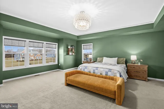 a aerial view of a house with swimming pool next to a yard