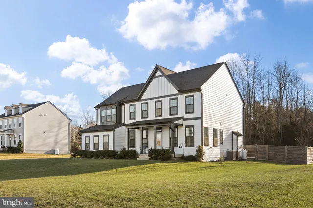 a view of a livingroom with wooden floor and furniture