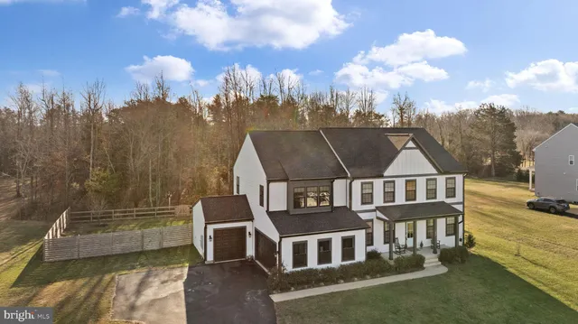 a living room with furniture kitchen view and a window