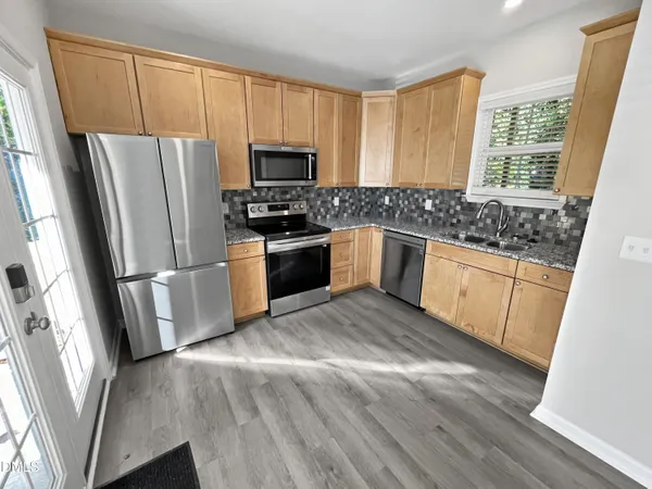 a kitchen with a refrigerator a sink and a stove