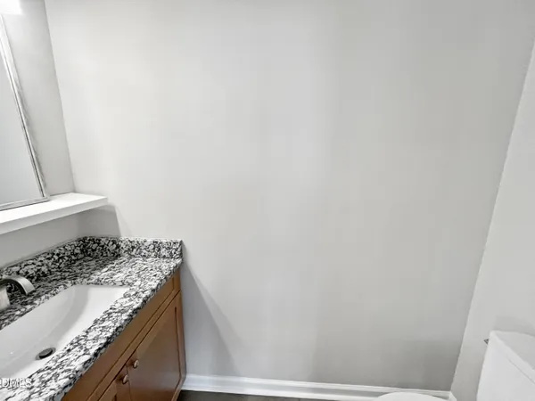 a view of a roof deck with couches and sky view