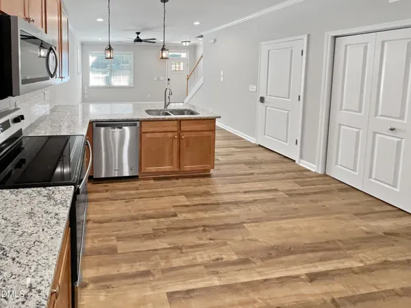 a kitchen with stainless steel appliances granite countertop a sink stove and refrigerator