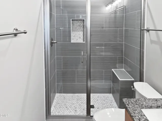 a view of a hallway with wooden floor and entryway