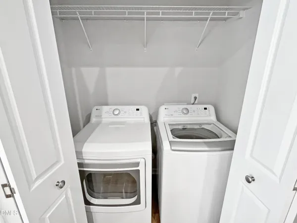 a bathroom with a granite countertop double vanity sink a mirror and a shower