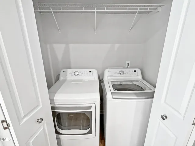 a bathroom with a granite countertop double vanity sink a mirror and a shower