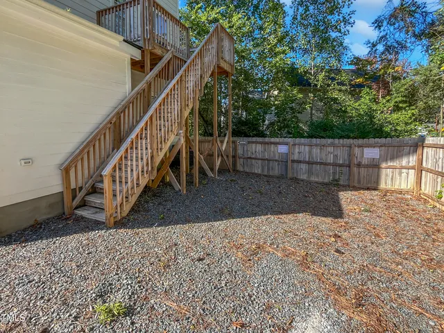 a view of a backyard with a small deck