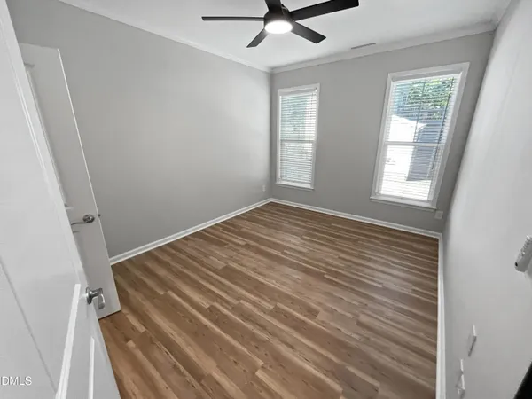 wooden floor in an empty room with a window