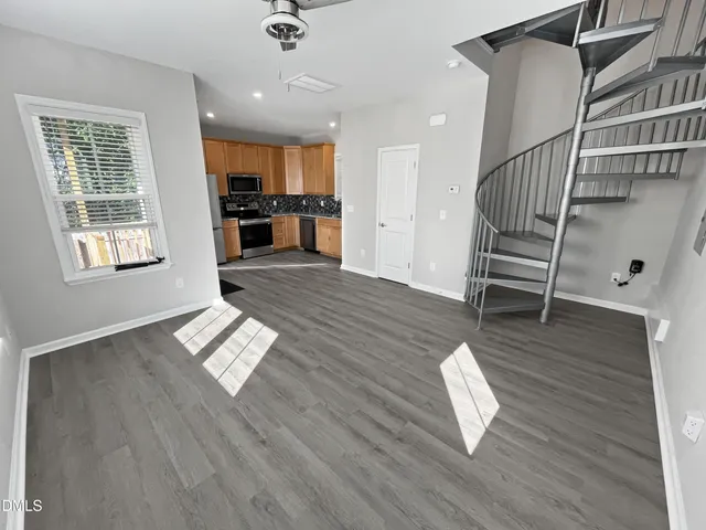 a bathroom with a granite countertop sink and a toilet
