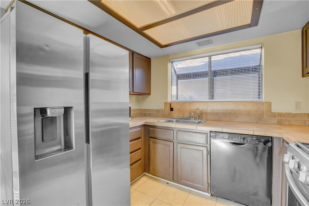 6440 Hartwood Road Las Vegas, NV 89108 - Photo 21 of 59 This kitchen showcases ample cabinet storage and modern appliances, perfect for culinary endeavors.