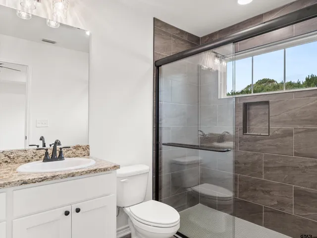 a view of kitchen with granite countertop cabinets