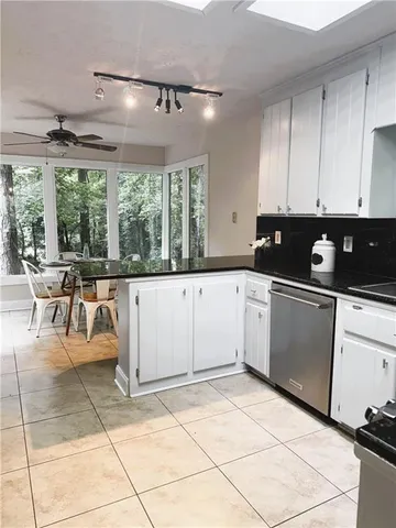 a kitchen with a sink a counter top space cabinets and stainless steel appliances