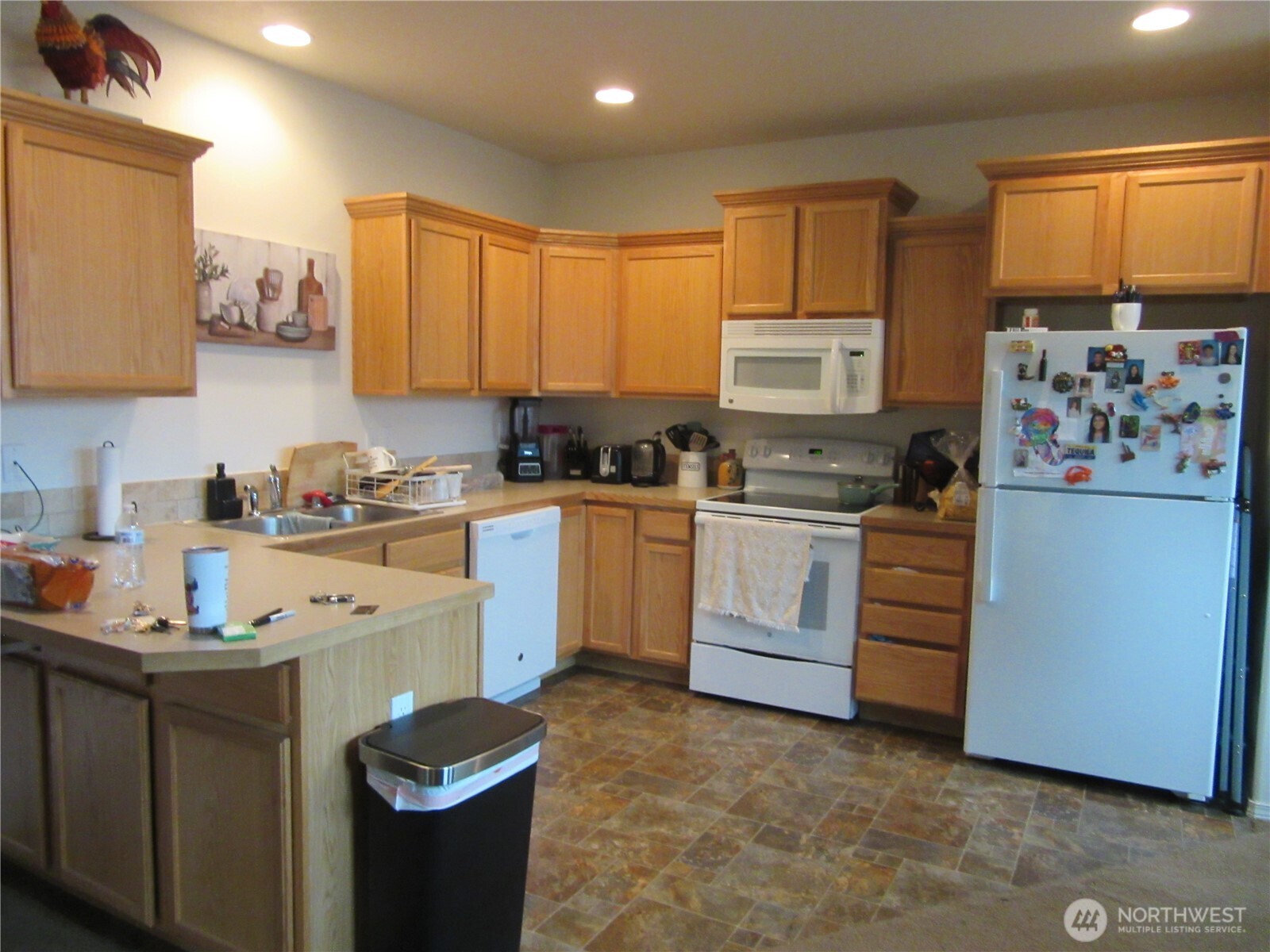1011 South 3rd Street Dayton, WA 99328 - Photo 4 of 10 a kitchen with white cabinets and white appliances