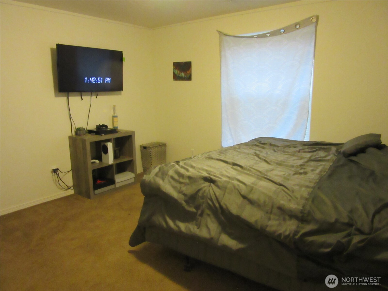 1011 South 3rd Street Dayton, WA 99328 - Photo 7 of 10 a bedroom with a bed and a flat screen tv