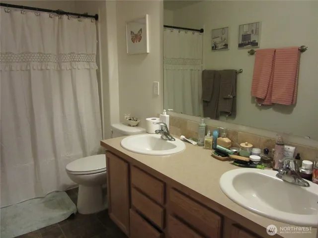 a bathroom with a sink toilet and a mirror