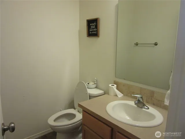 a bathroom with a sink a toilet and a mirror