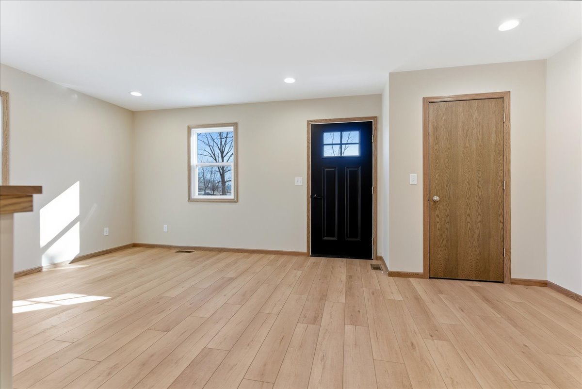 313 East Martin Street Forrest, IL 61741 - Photo 27 of 50 a view of an empty room with wooden floor and a window