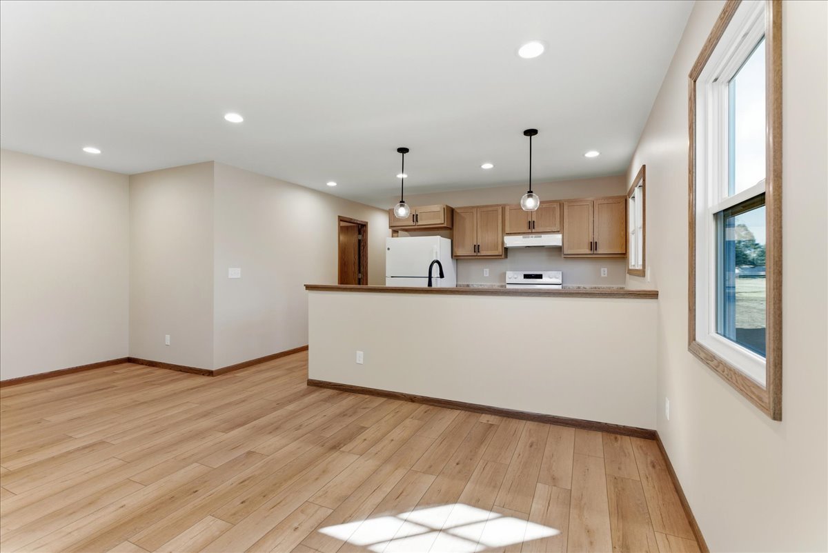 313 East Martin Street Forrest, IL 61741 - Photo 28 of 50 a large white kitchen with a large counter top a sink stainless steel appliances and cabinets