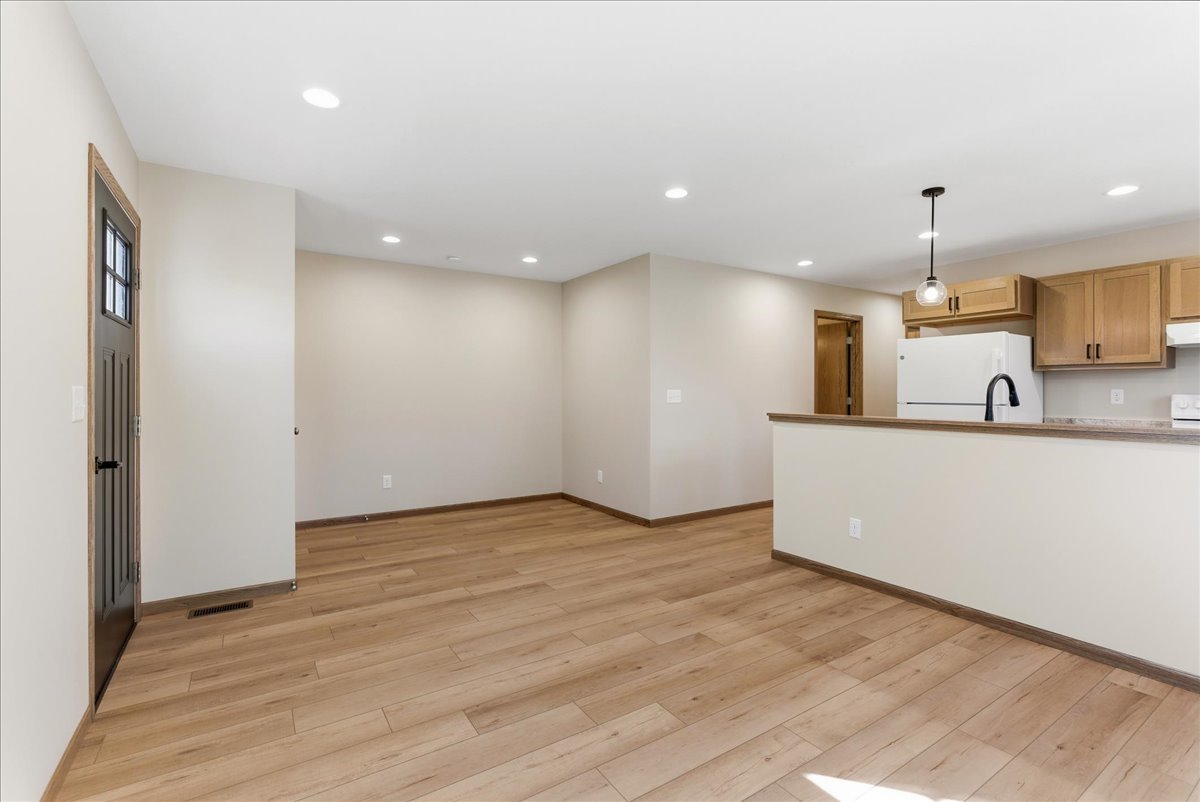 313 East Martin Street Forrest, IL 61741 - Photo 30 of 50 an empty room with wooden floor and windows