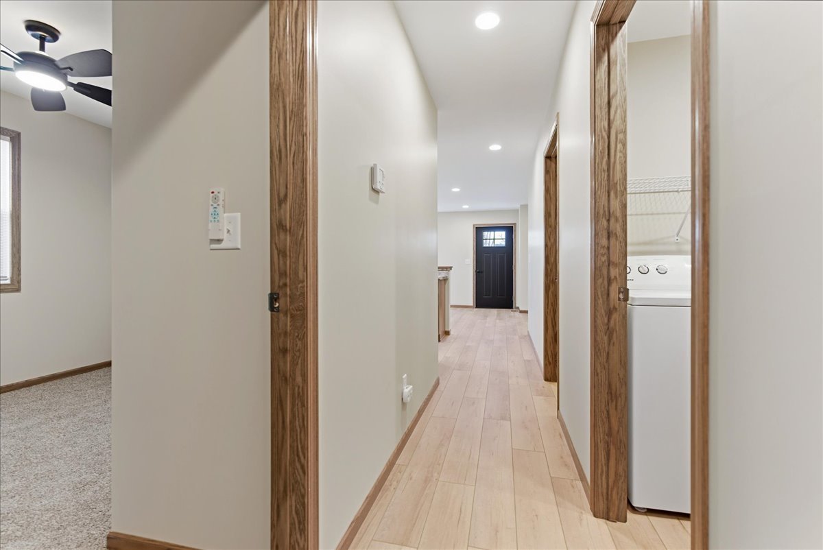 313 East Martin Street Forrest, IL 61741 - Photo 38 of 50 a view of a hallway with a large mirror and a refrigerator