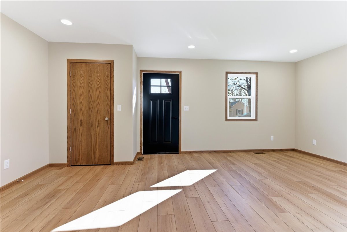 313 East Martin Street Forrest, IL 61741 - Photo 4 of 50 a view of an empty room with wooden floor and a window
