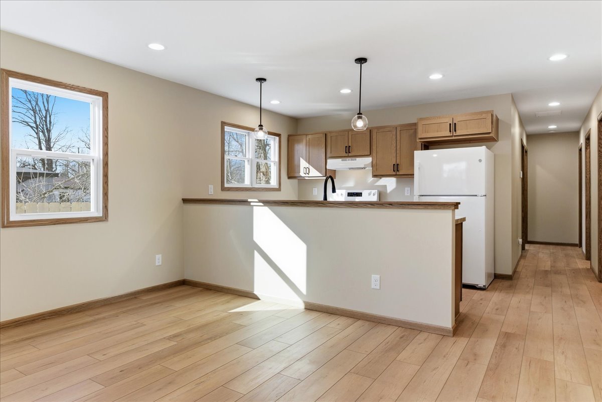 313 East Martin Street Forrest, IL 61741 - Photo 6 of 50 a kitchen with stainless steel appliances a refrigerator a sink dishwasher a stove and white cabinets with wooden floor