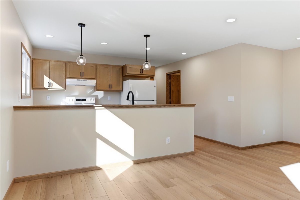 313 East Martin Street Forrest, IL 61741 - Photo 7 of 50 a kitchen with kitchen island a stove a wooden floors and a kitchen island