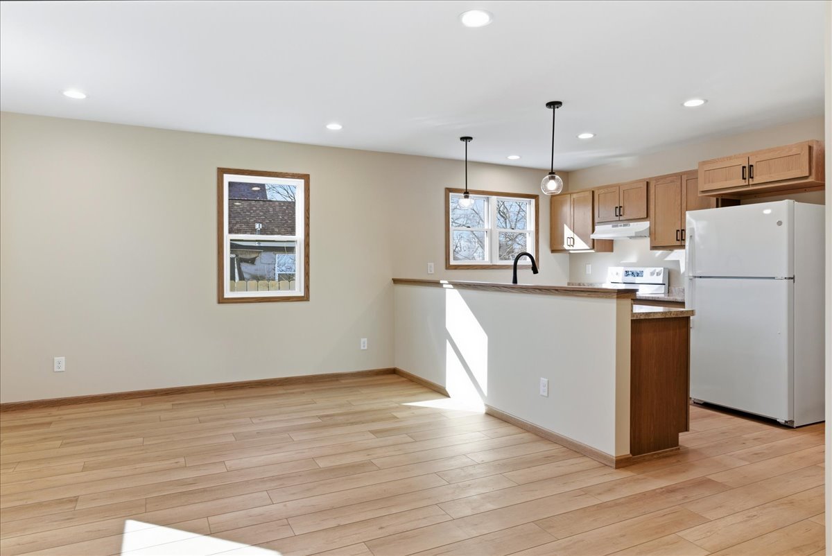 313 East Martin Street Forrest, IL 61741 - Photo 8 of 50 a kitchen with stainless steel appliances a refrigerator a sink dishwasher a stove white wooden cabinets and wooden floor